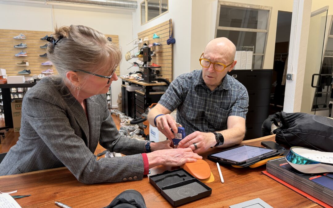 Two people utilizing ASTM hardness testing for a foam insole.